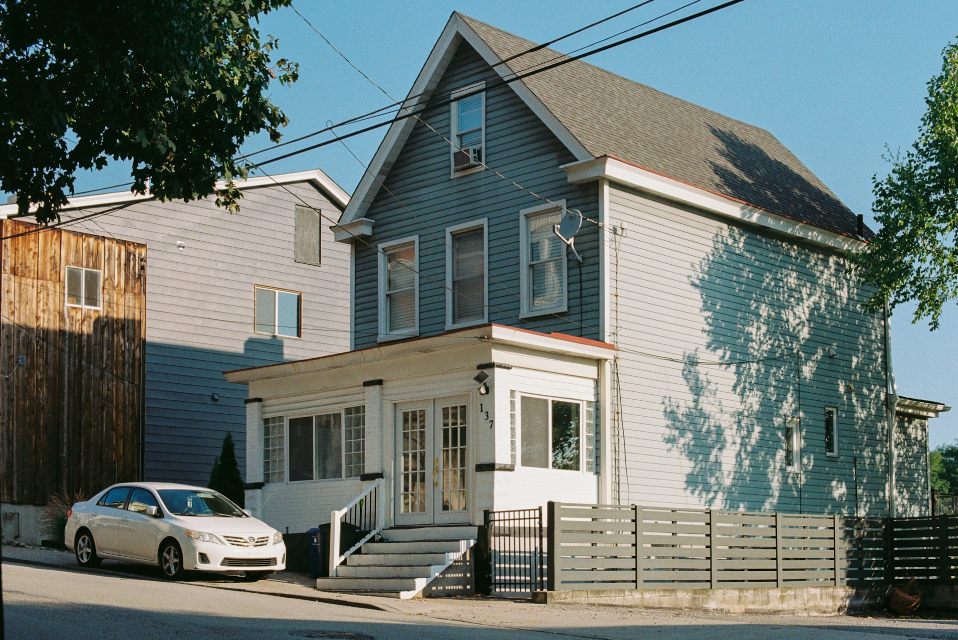 A car is parked in front of a house